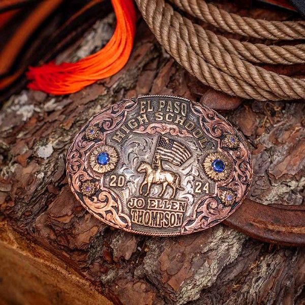 A custom women's belt buckle for El Paso High School with personalized name featuring a goldenb bronze cowgirl with US flag figure